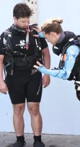 Instructor buddy checking a student